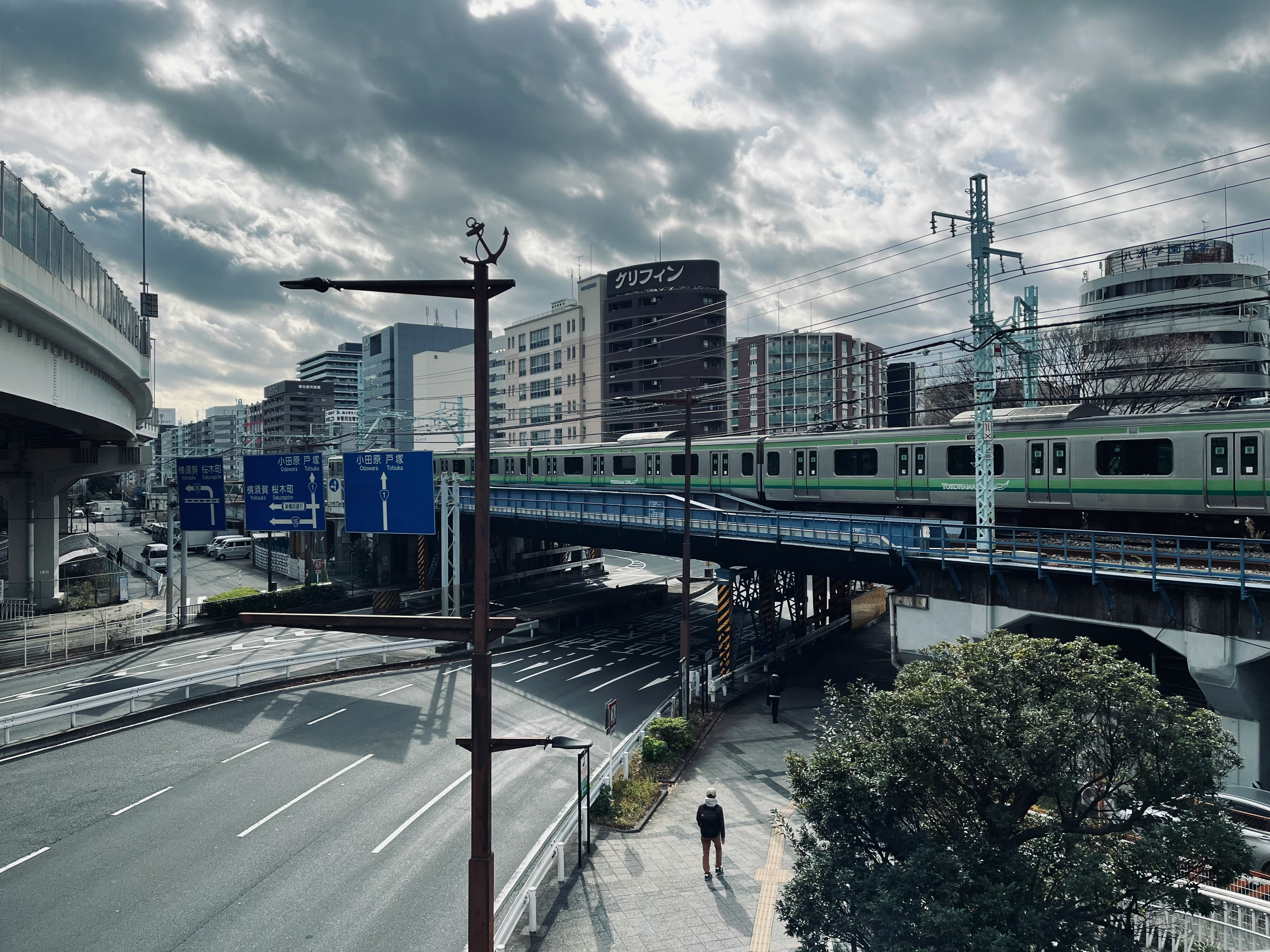Cloudy city scene in Yokohama with buildings and street detail.